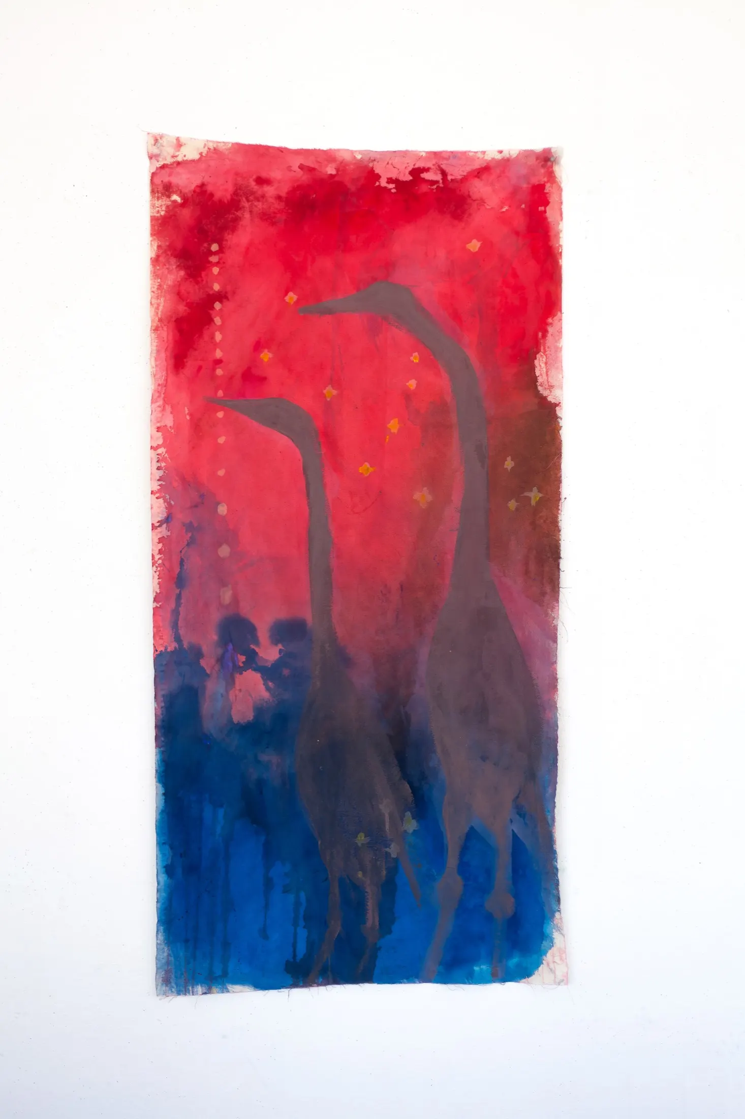 Painting on fabric of two dark long-necked herons against a red upper field fading into deep blue below.