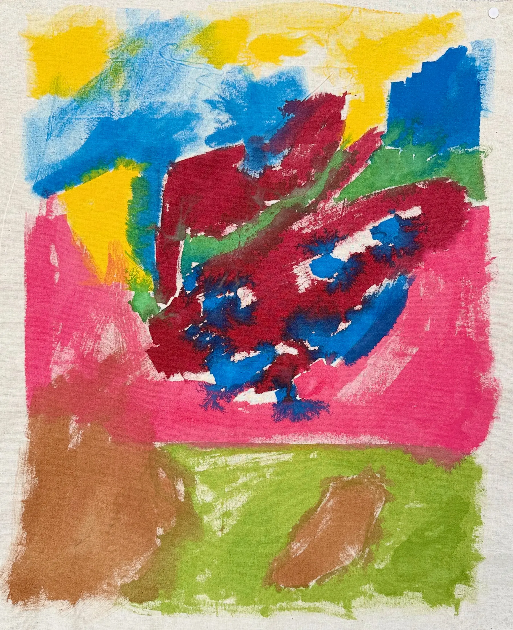 Close view of an abstract painting on raw fabric with yellow, blue, magenta, pink, green, and brown zones.
